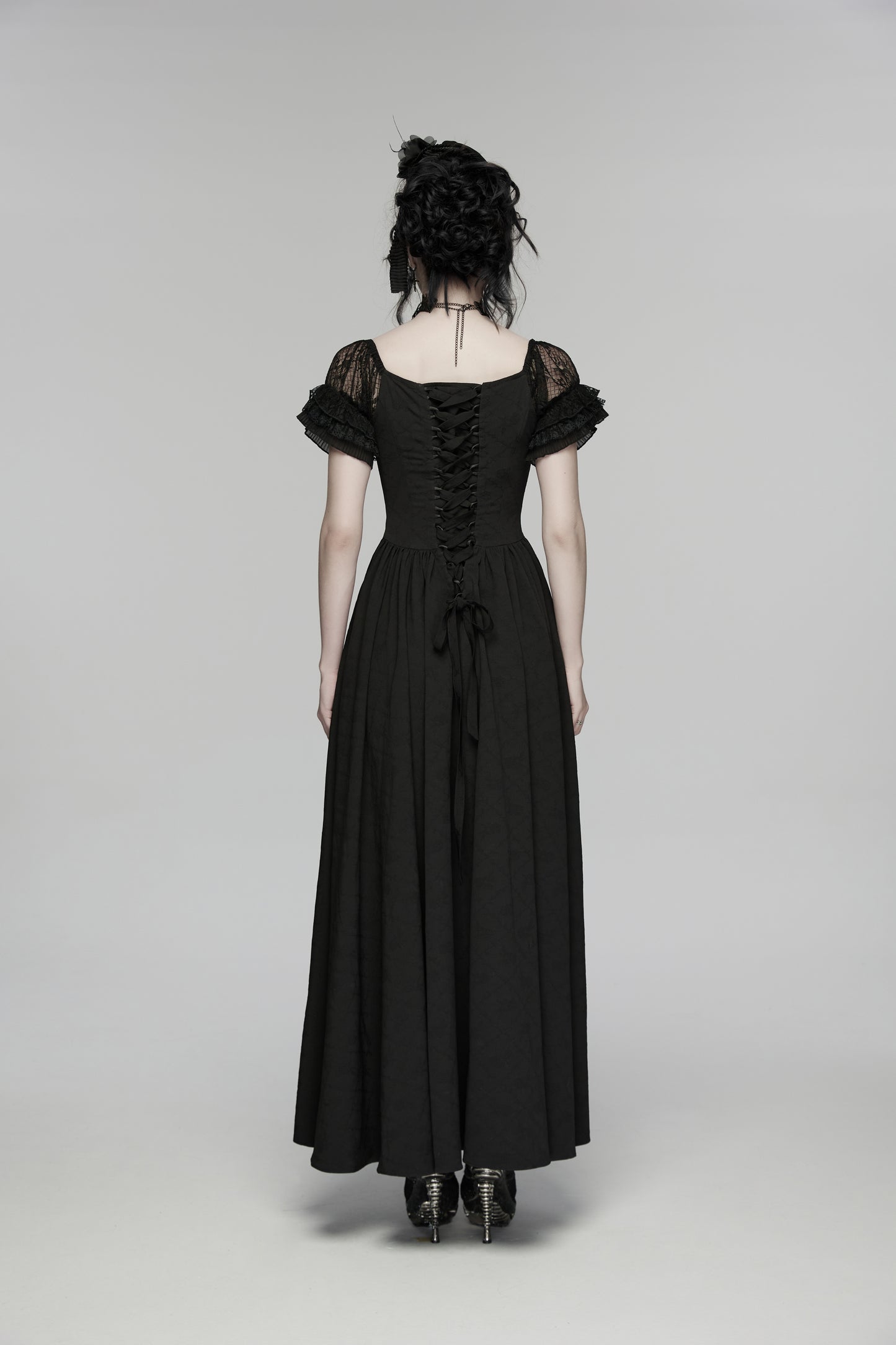 Back view of a goth maxi dress featuring lace accents and flowing silhouette.