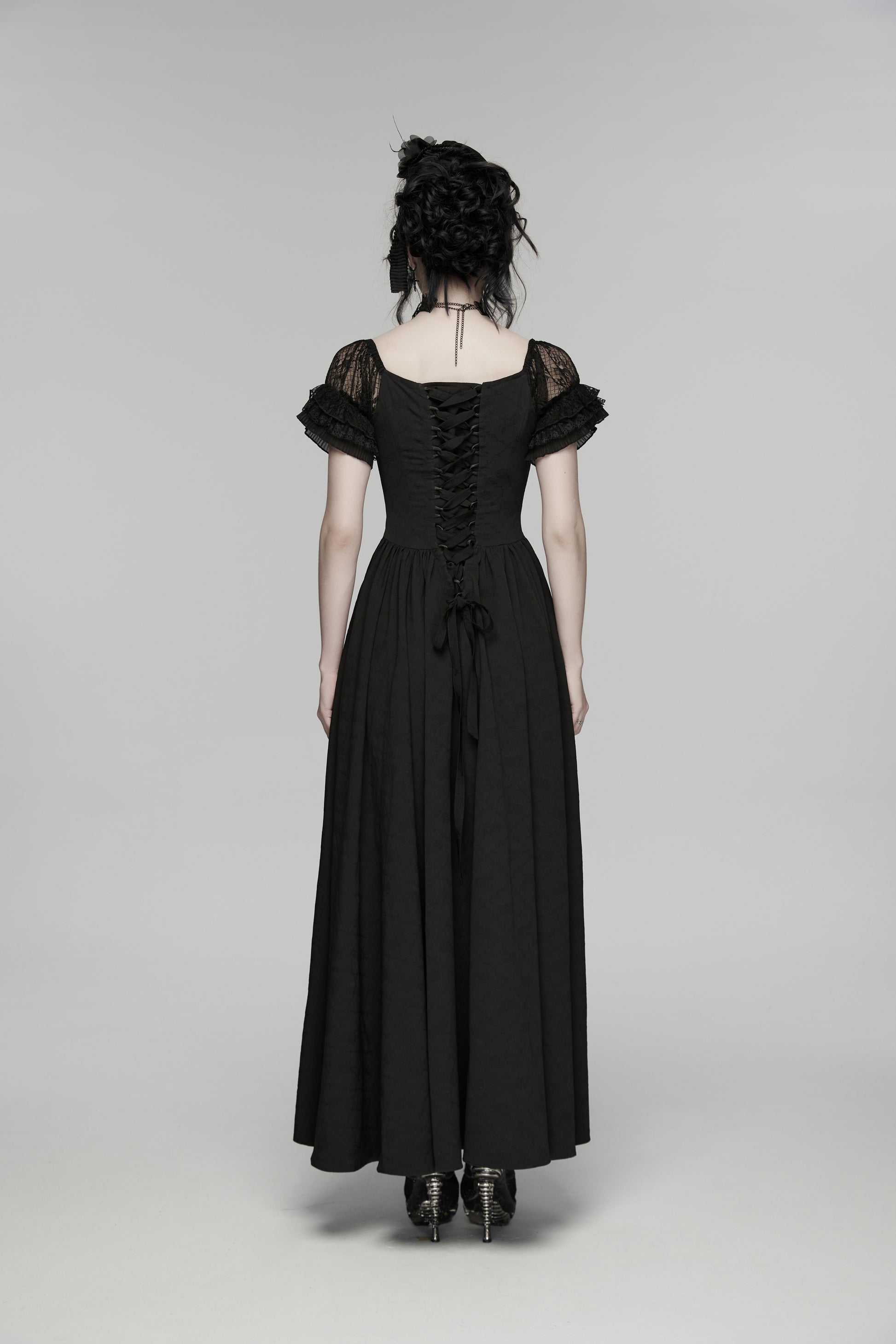 Back view of a goth maxi dress featuring lace accents and flowing silhouette.