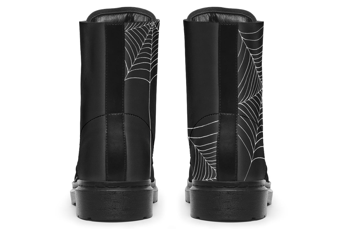 Black boots with spider web design on a white background