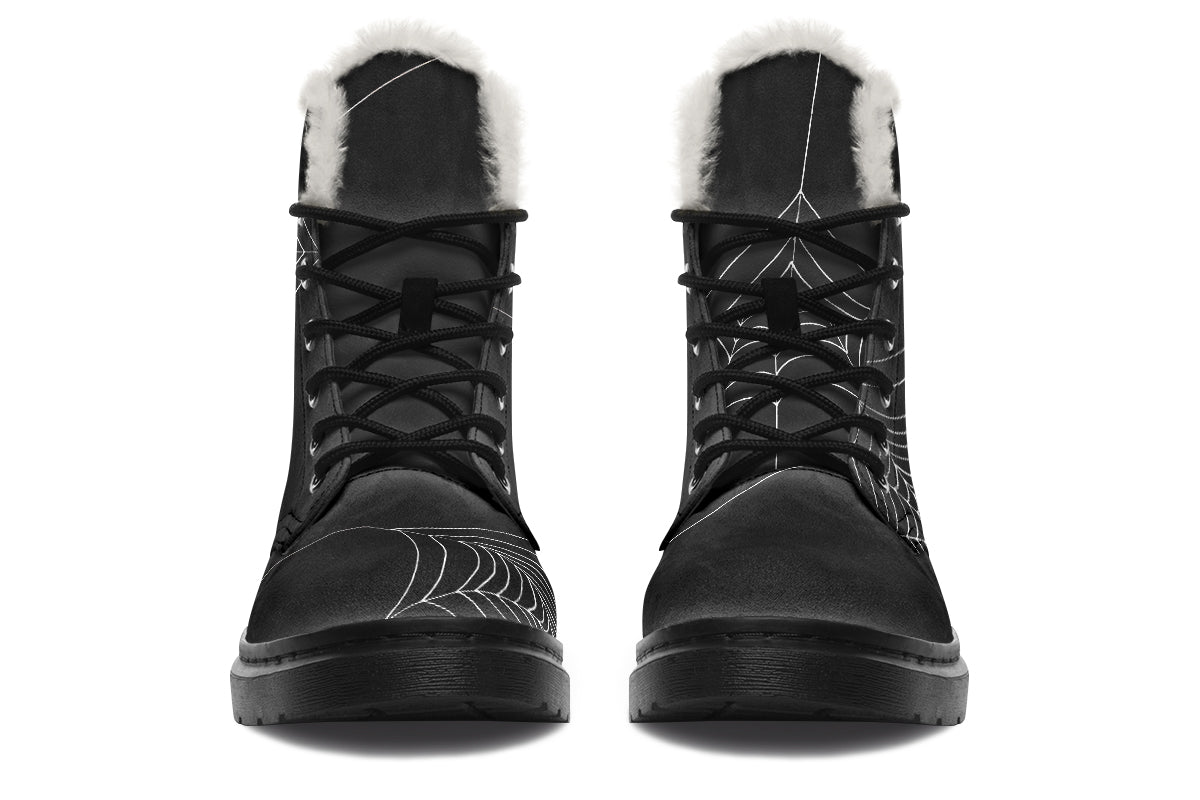 Black winter boots with fur lining on a white background
