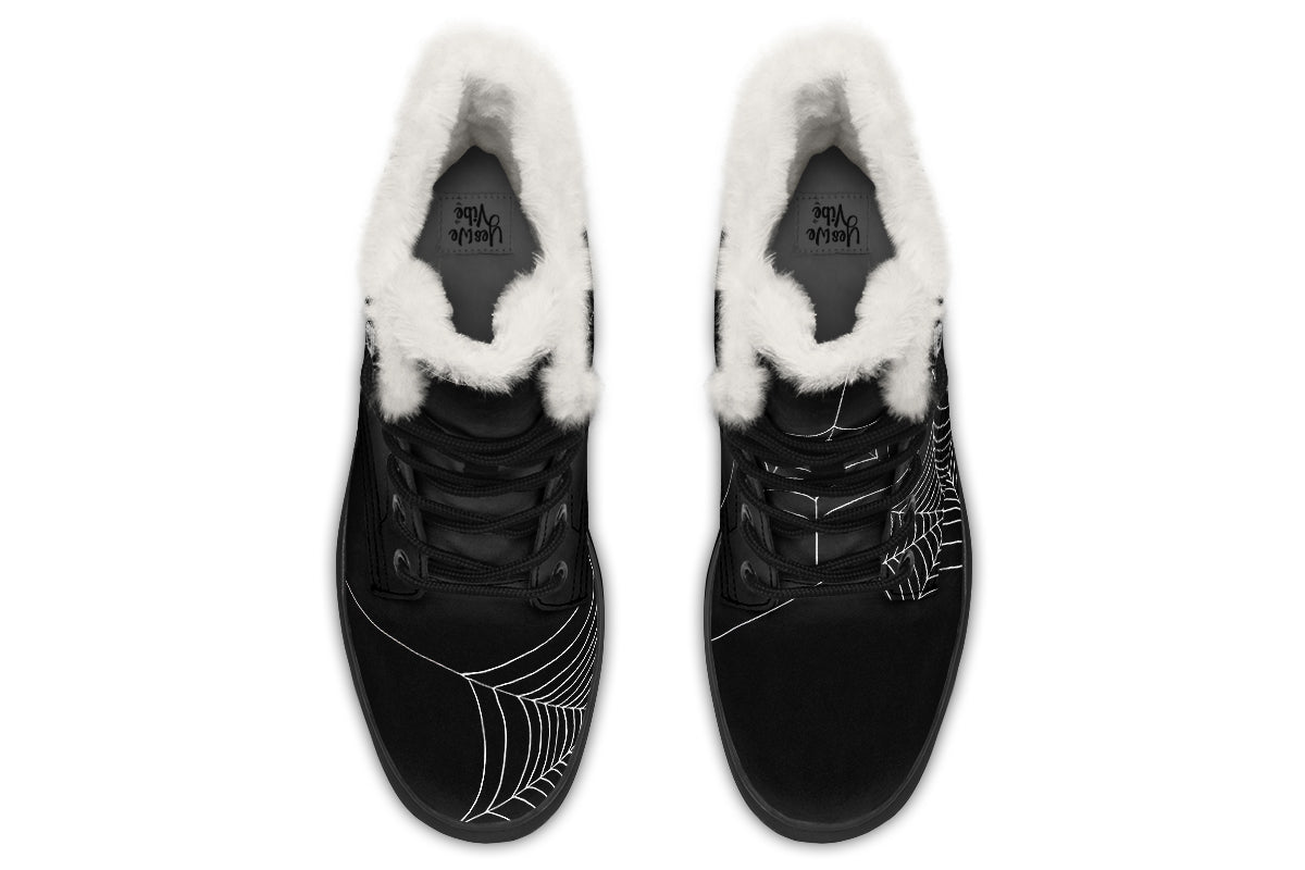 Black winter boots with white fur lining on a white background