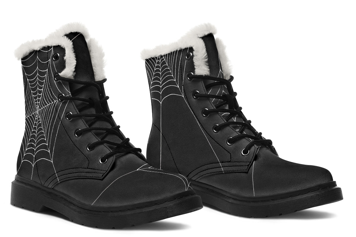 Black combat boots with spider web pattern and white fur lining on a white background