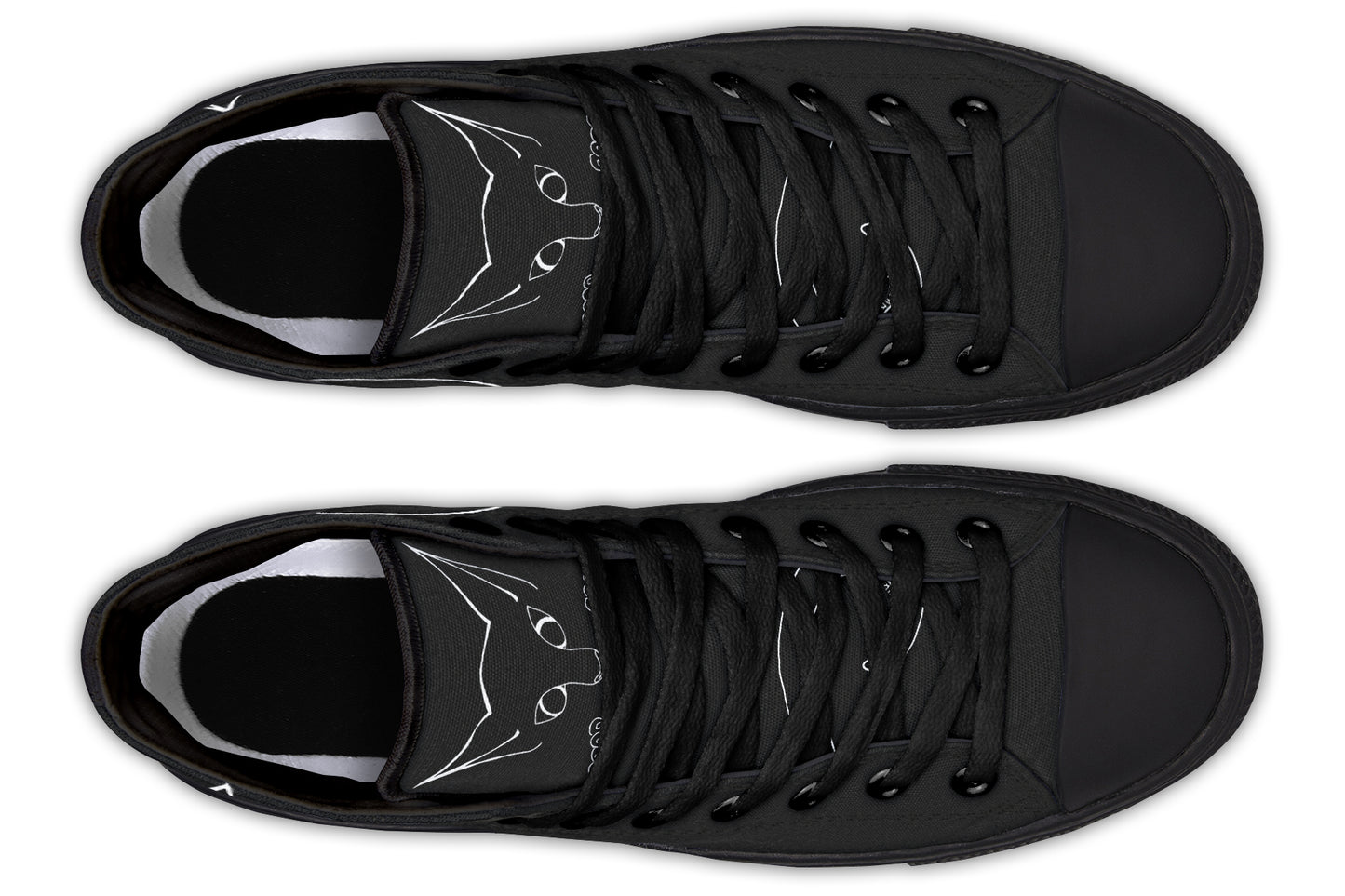 Pair of black sneakers with white cat designs on a white background