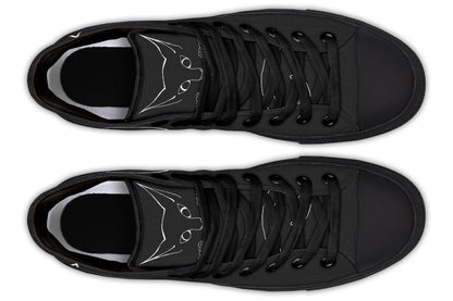 Pair of black sneakers with white cat designs on a white background