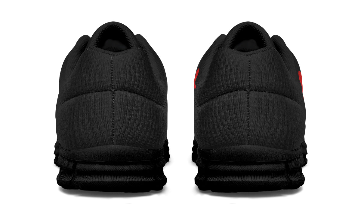Black athletic shoes shown from the back on a white background