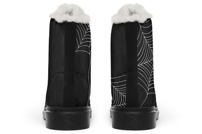 Black boots with spider web design and white fur lining on a white background