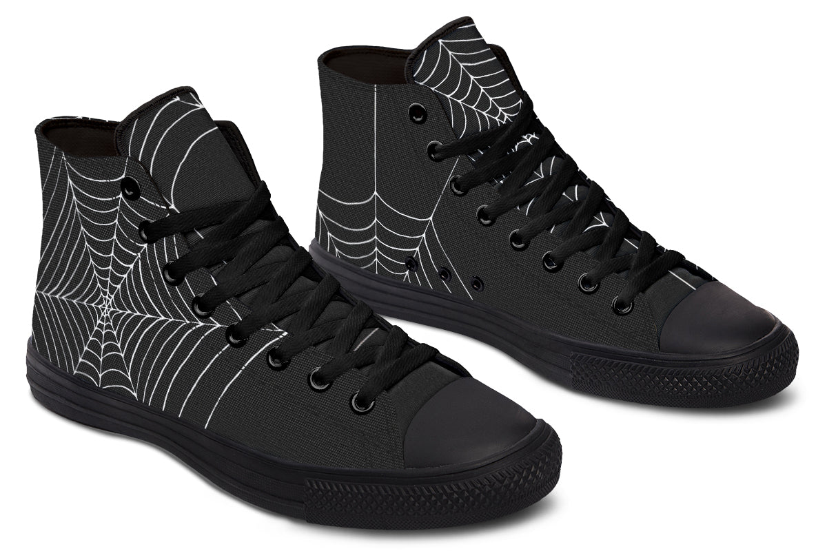 Black high-top sneakers with spider web design on a white background