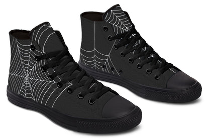 Black high-top sneakers with spider web design on a white background