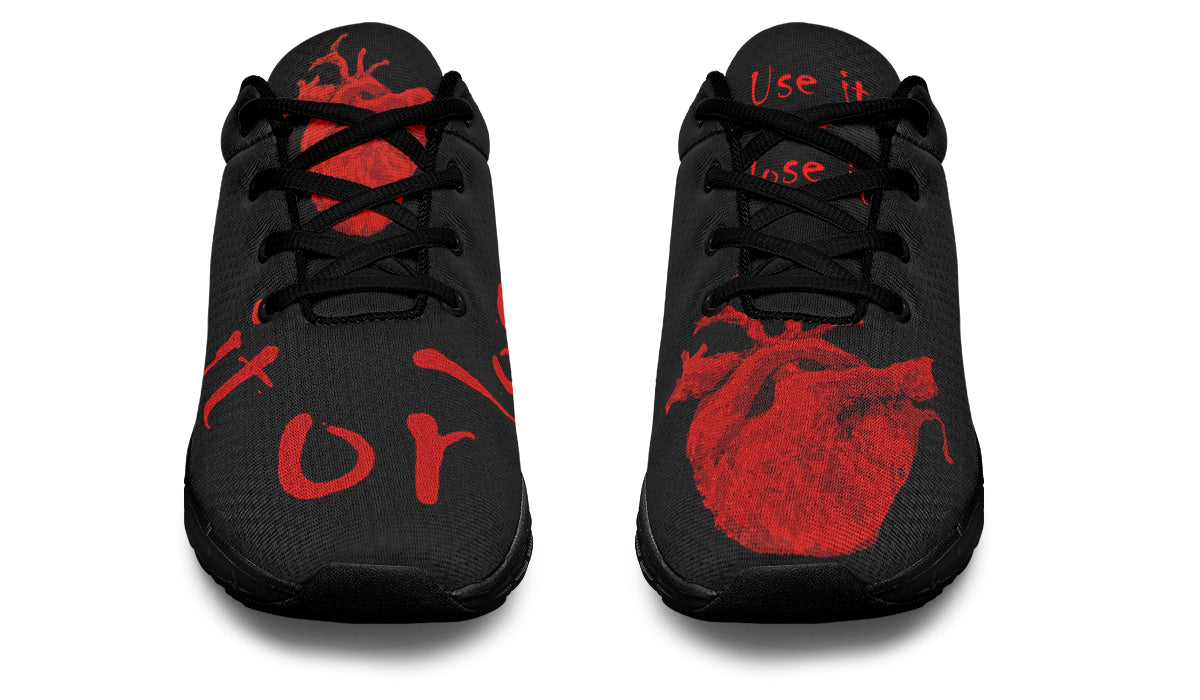 Black and red trainers with anatomical heart design and creepy text "Use it or lose it"