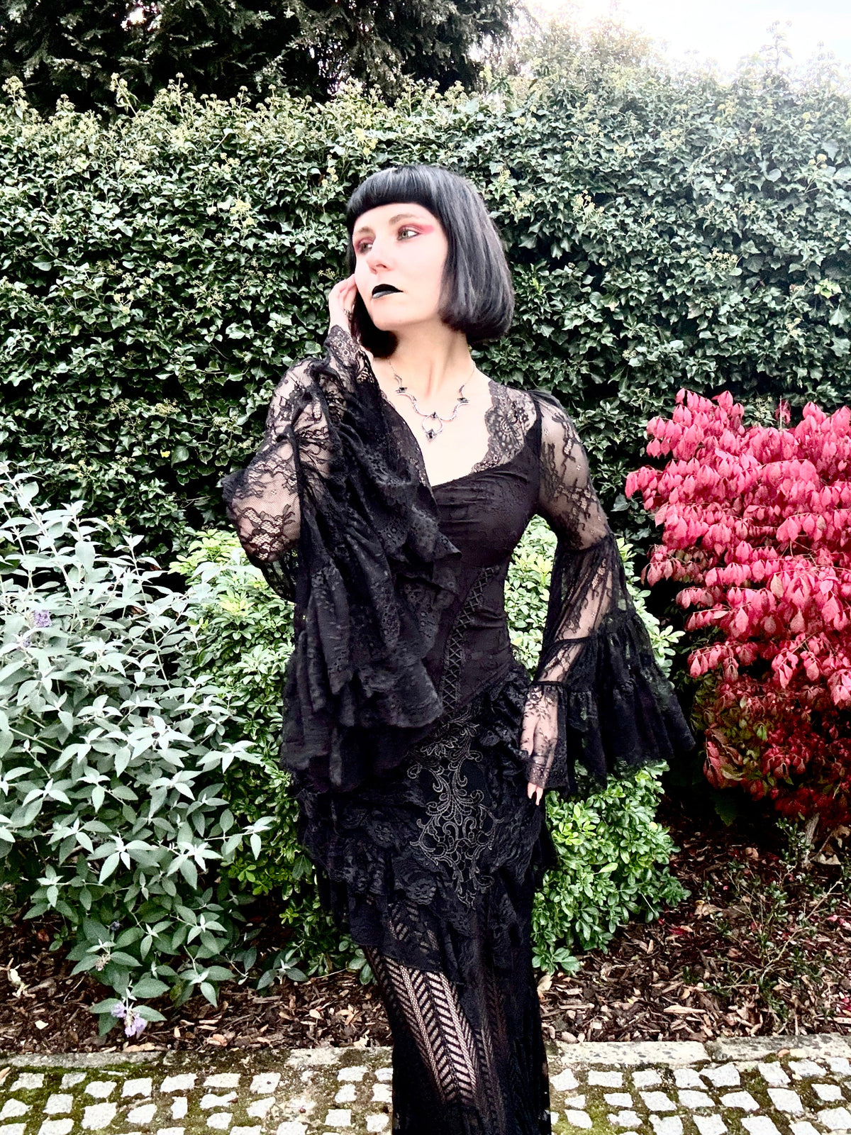 Julia Rose Noir wearing the Punk Rave Rowena Gothic Fishtail Maxi Skirt with the Dark in Love Zuri Gothic Lace Bell Sleeve Top