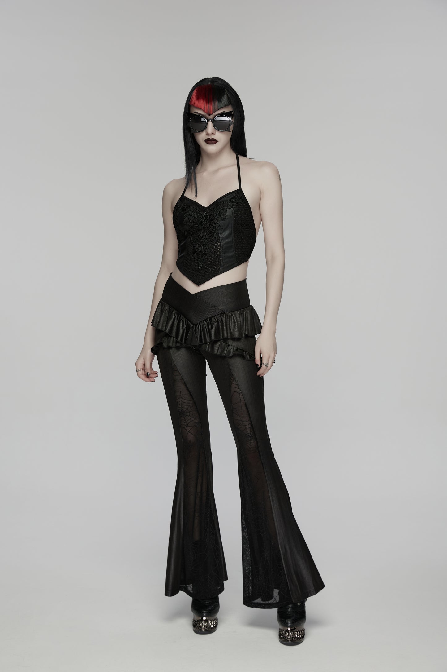 Model wearing a black Punk Rave Bellatrix Goth Leggings Flares - Spiderweb Panel Alt Flared Trousers