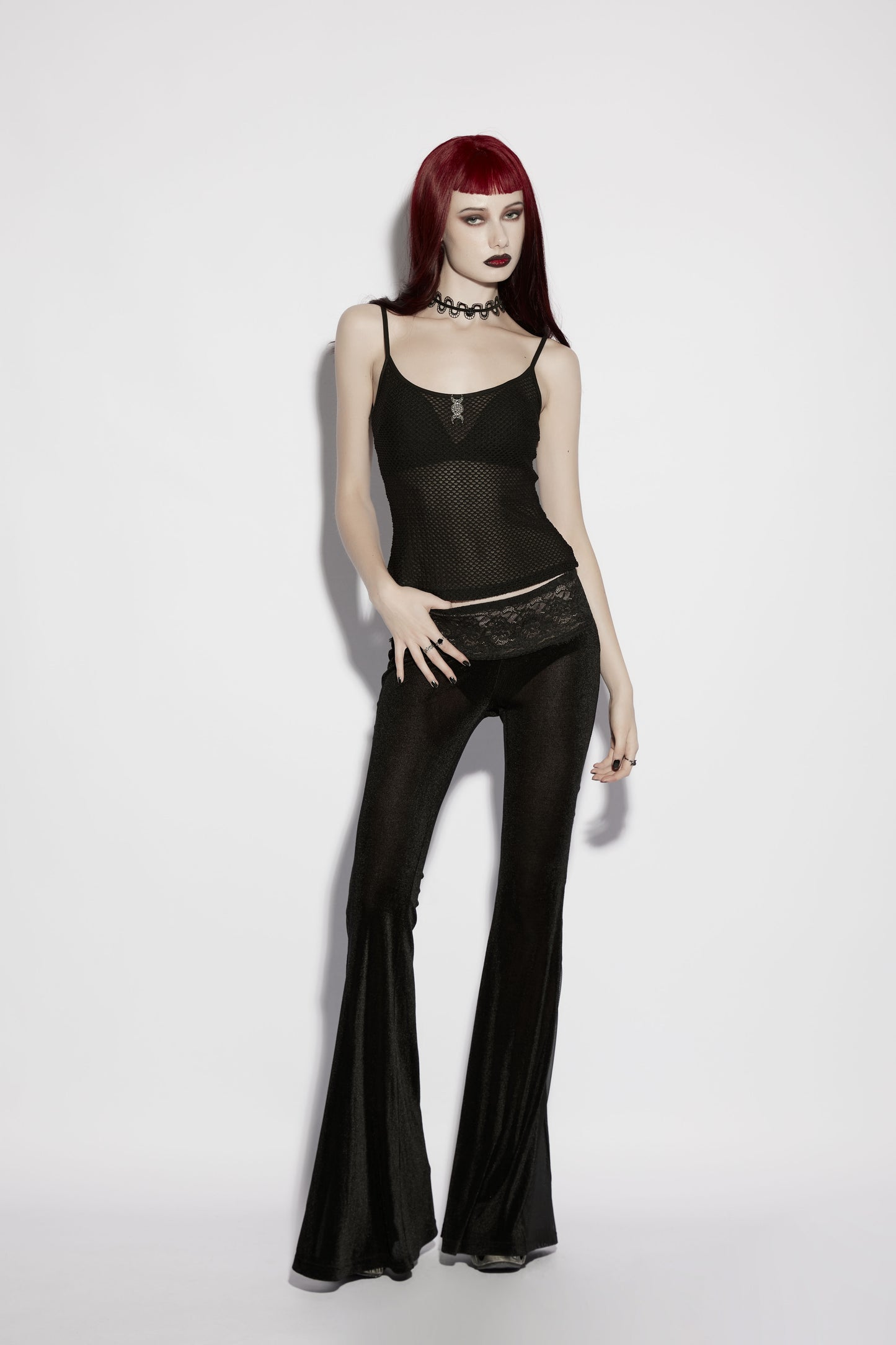 Model wearing Punk Rave Lilith Low Waist Flared Pants, showcasing dark alternative fashion style with dramatic silhouette.