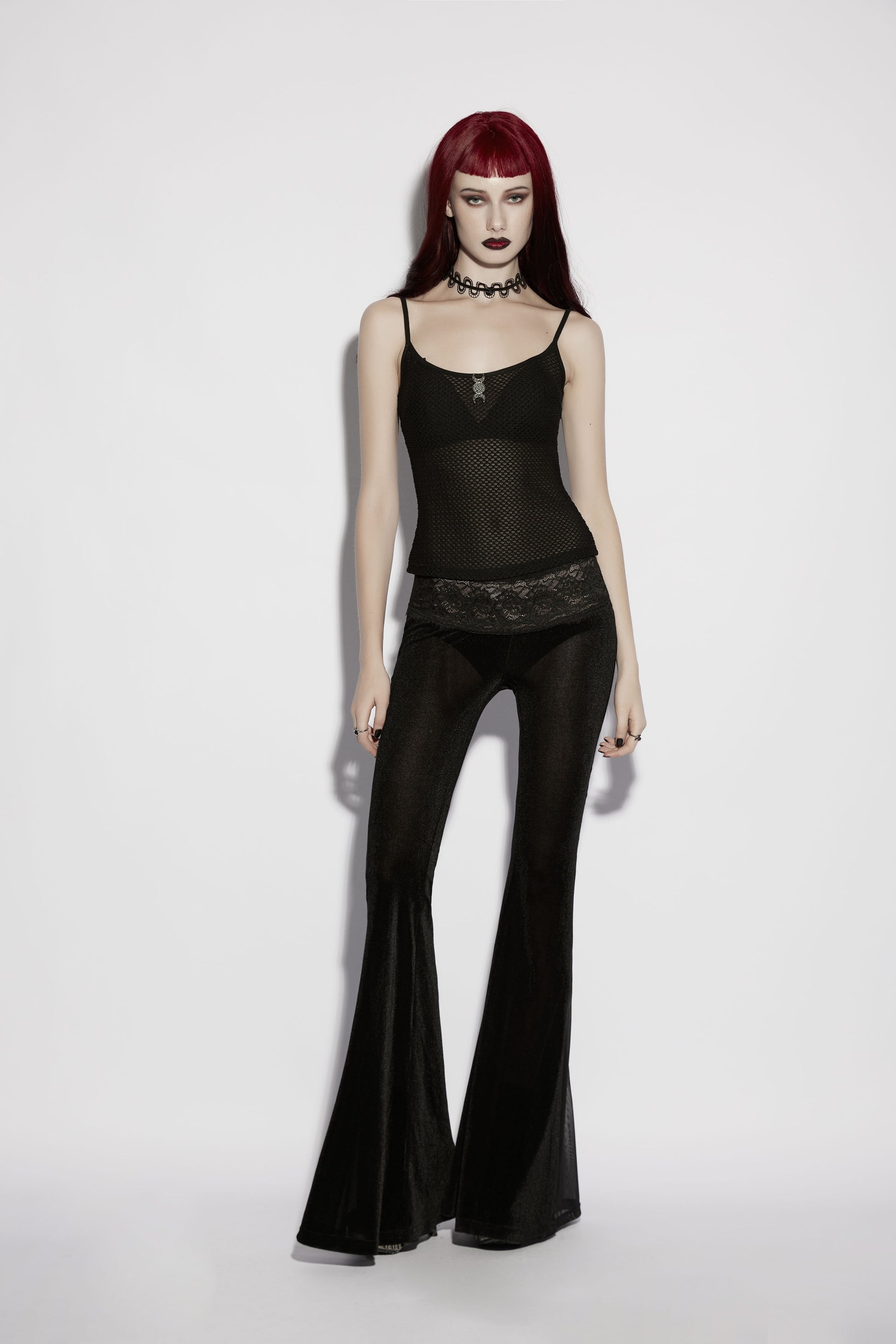 Punk Rave Lilith Low Waist Flared Pants styled with a sheer top, showcasing alternative fashion aesthetics.