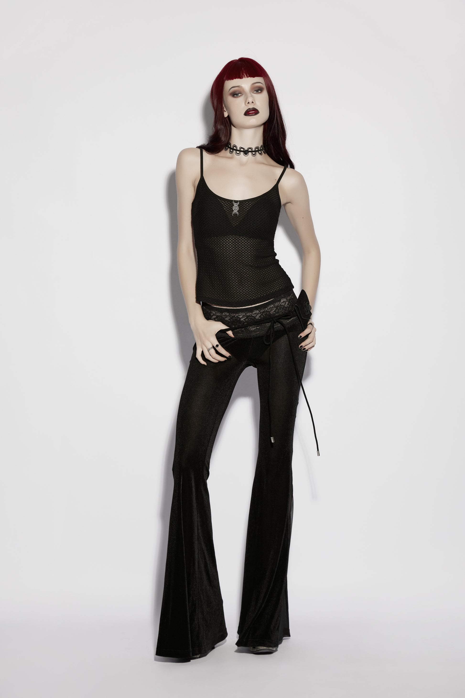 Model wearing Punk Rave Lilith Low Waist Flared Pants, showcasing an edgy gothic style with a dramatic silhouette.