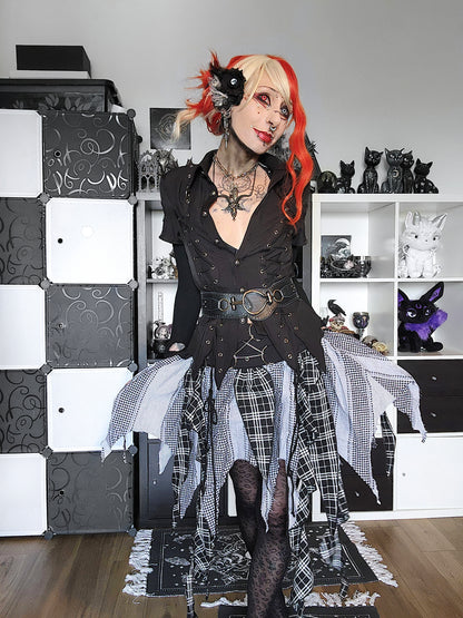 Valentinescorpse in a gothic outfit with plaid and black elements, standing in a room with decorative items.
