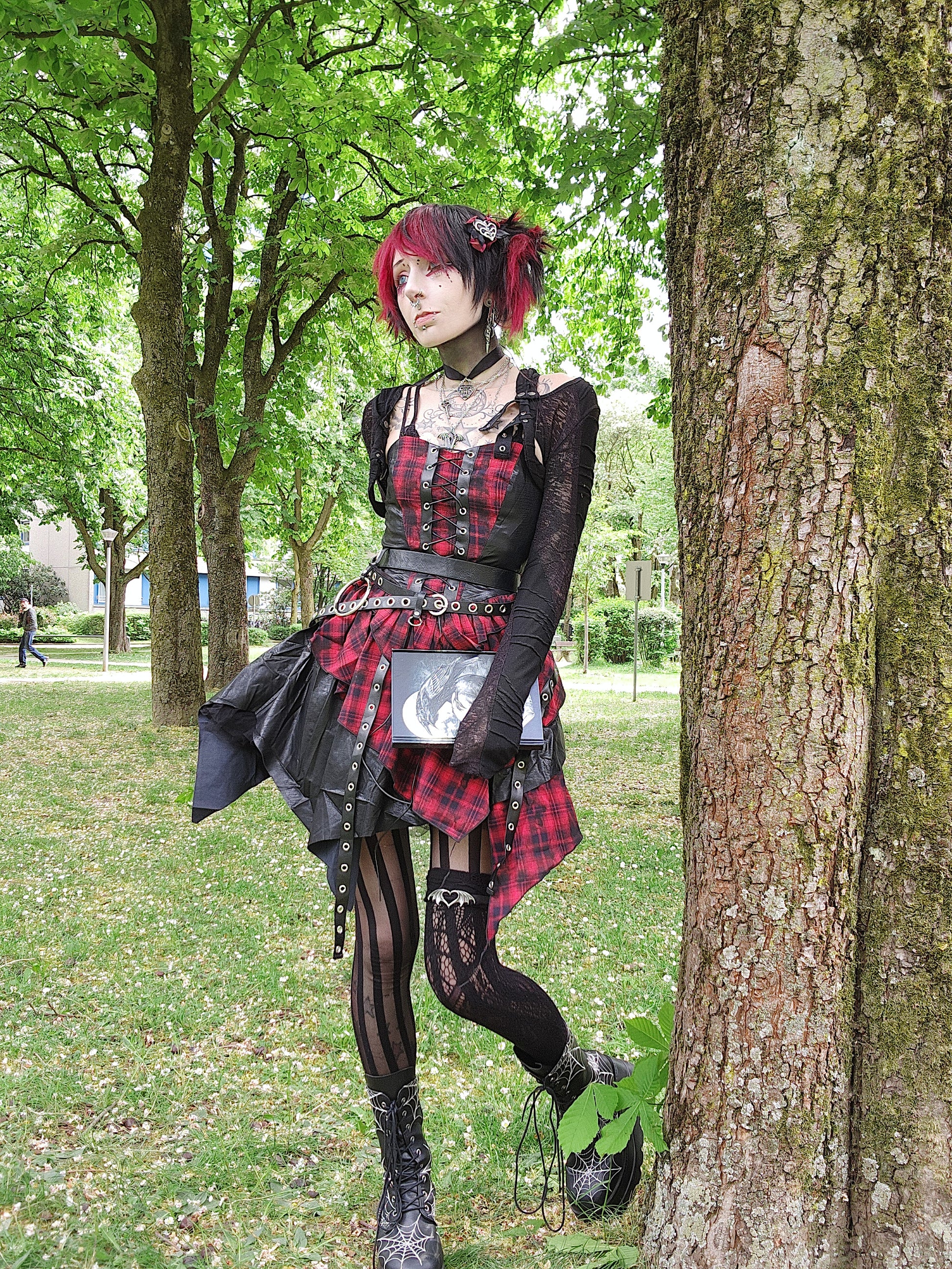 Valentinescorpse wearing Dark in Love Red Tartan Corset Punk Dress with Handkerchief Skirt in a park setting