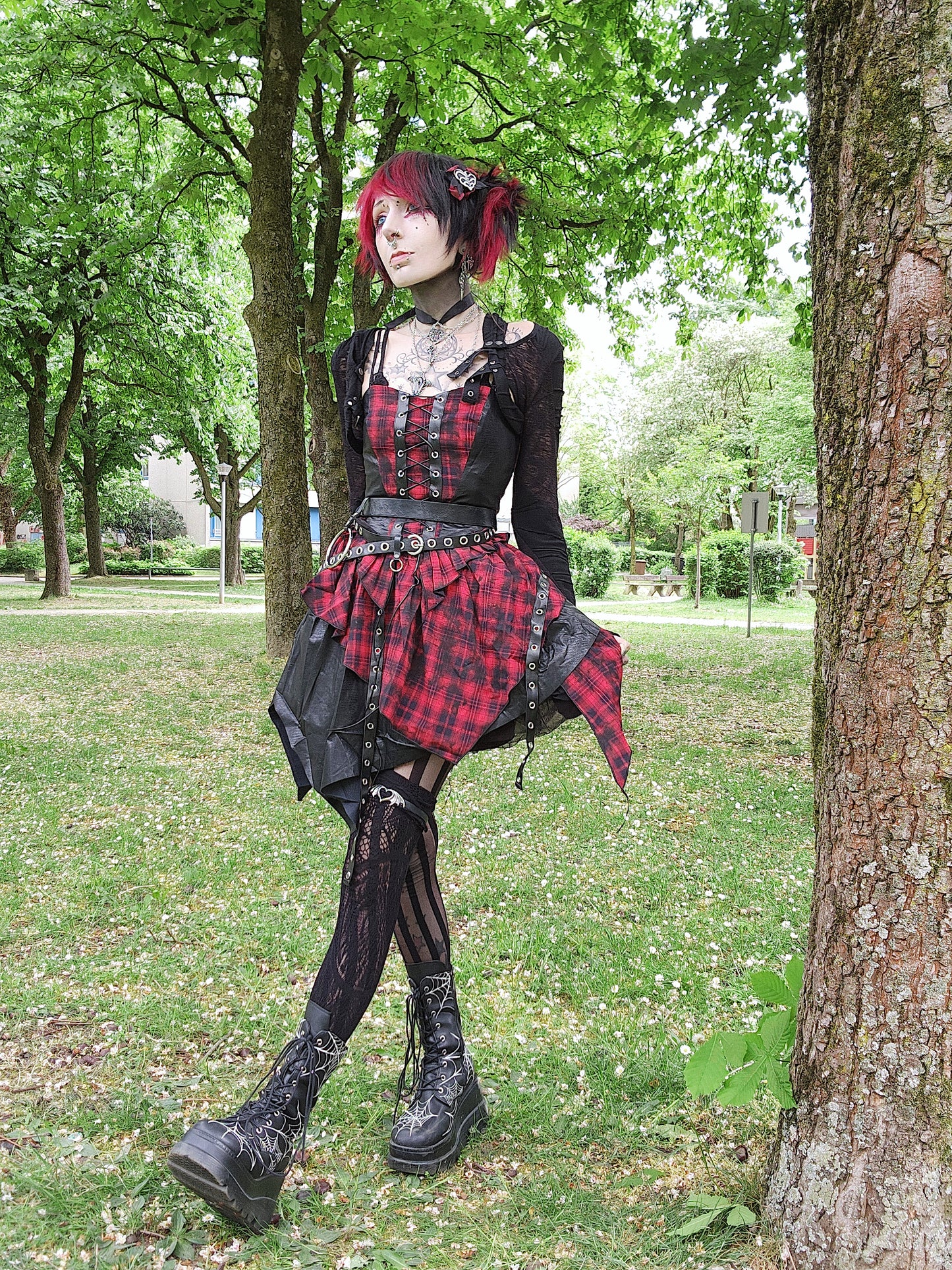 Valentinescorpse wearing Dark in Love Red Tartan Corset Punk Dress a park setting
