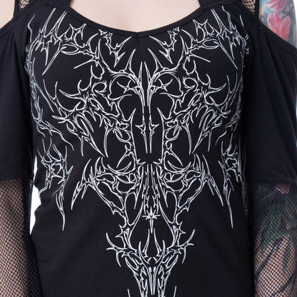 Black shirt with white intricate design worn by a person with tattoos.