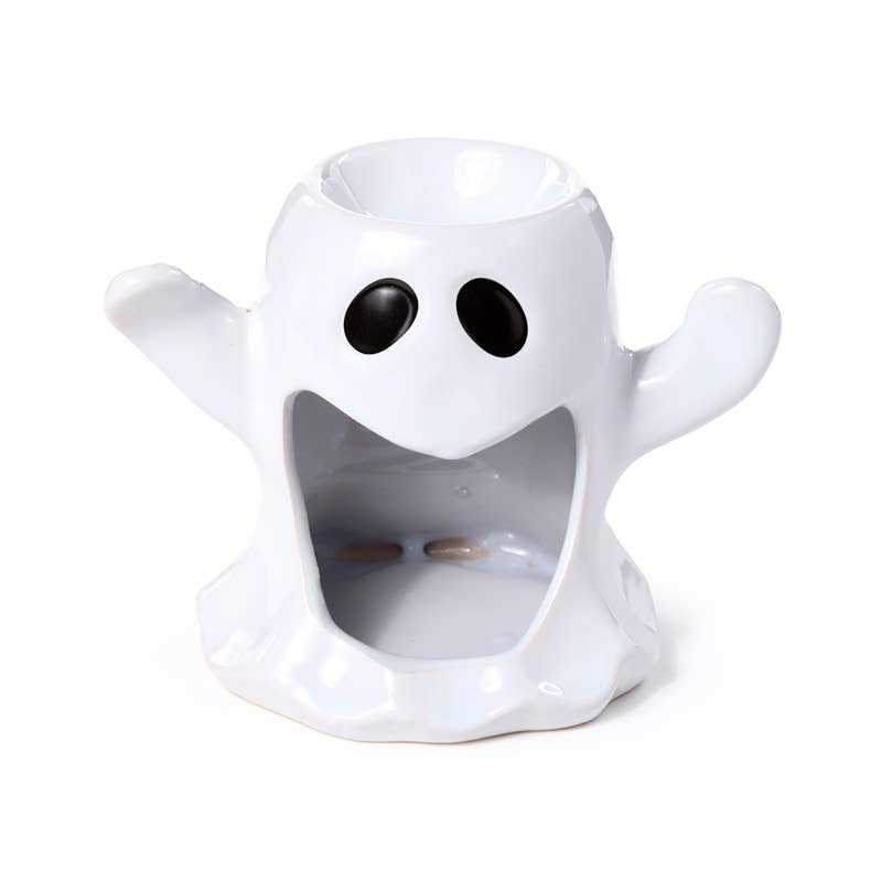 White ghost-shaped candle holder with black eyes on a white background