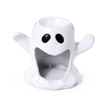 White ghost-shaped candle holder with black eyes on a white background