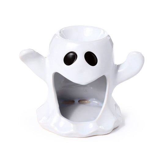 White ghost-shaped candle holder with black eyes on a white background