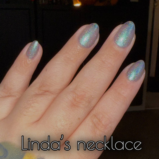 Radioactive Unicorn Linda’s Necklace Nail Polish applied on fingers with iridescent holographic shimmer.