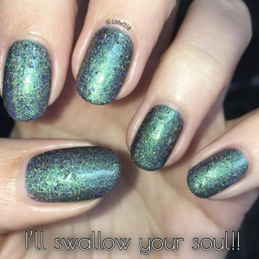 green holographic duochrome nail polish on fingers with a warning text saying I'll swallow your soul