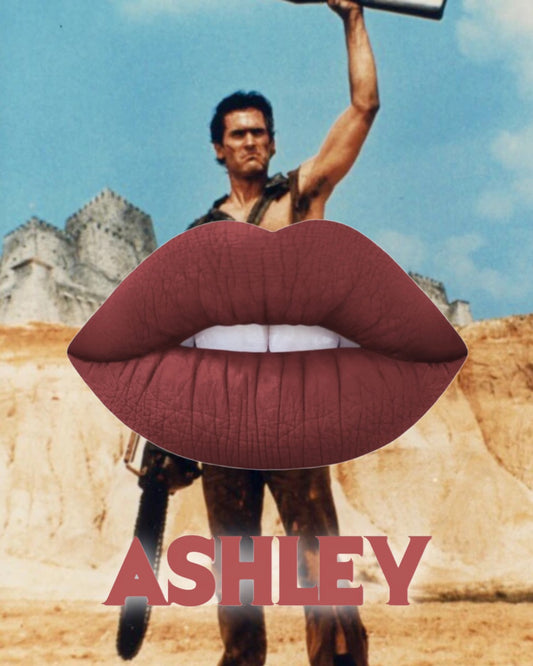 Brown nude lipstick displayed over a dramatic image, emphasizing the Radioactive Unicorn Ashley Lipstick style and attitude.
