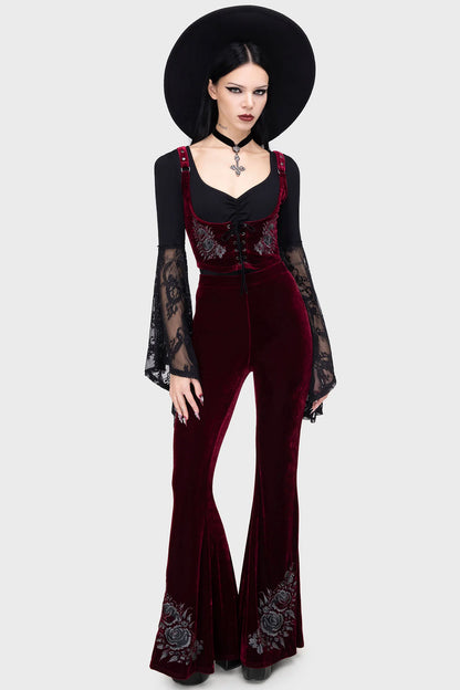 Front view of Killstar A Devil’s Rose flared trousers in deep red velvet with gothic embroidered roses