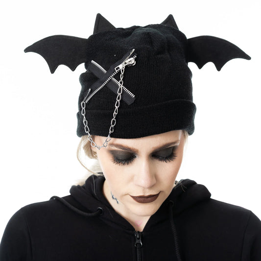 Black bat-winged beanie with chains worn by a person on a white background