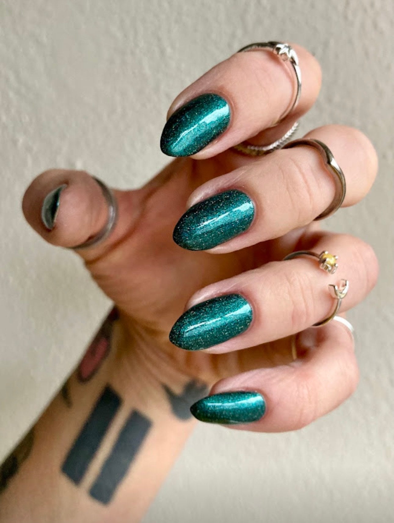 Radioactive Unicorn The Kraken emerald glitter nail polish on long nails showing shimmering ocean green finish