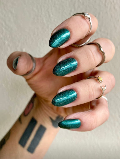 Radioactive Unicorn The Kraken emerald glitter nail polish on long nails showing shimmering ocean green finish