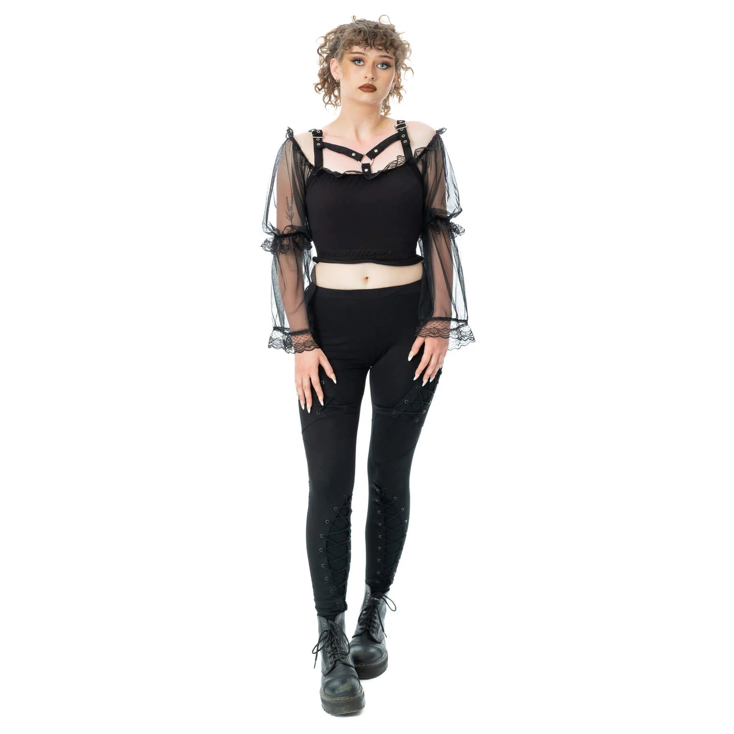 Model wearing Poizen Industries Shadowfang Top Black with a gothic style, paired with black leggings and ankle boots.