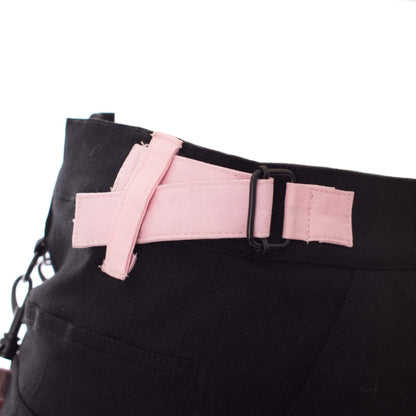 Gothic mini skirt black and pink strap detail showcasing adjustable buckle design for edgy alternative styling.